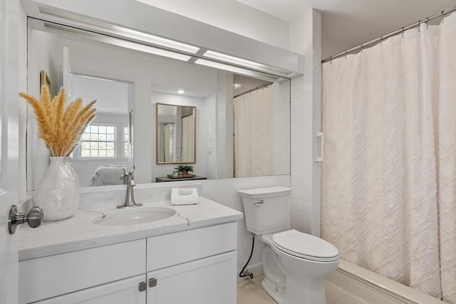 bathroom featuring vanity, a shower with shower curtain, tile patterned floors, and toilet