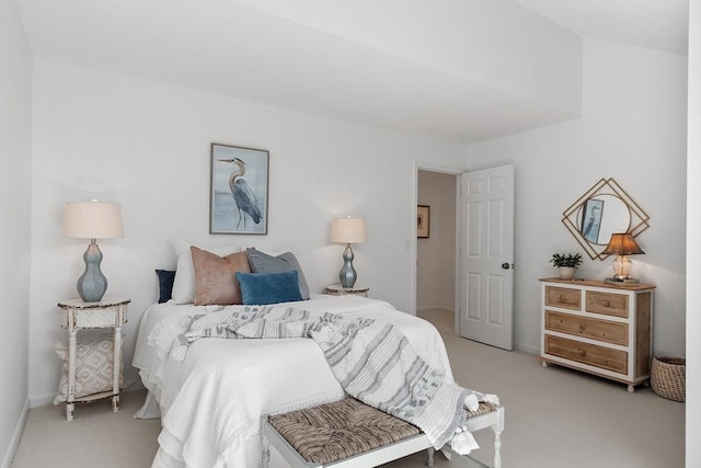 bedroom with baseboards and light carpet