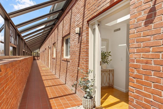 view of side of property featuring brick siding