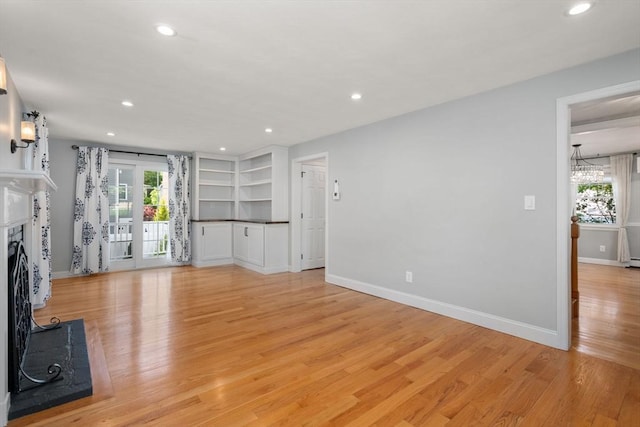 15 Janet Rd, Arlington, MA 02474 - unfurnished living room with light wood-type flooring, a fireplace, baseboards, recessed lighting, and a chandelier