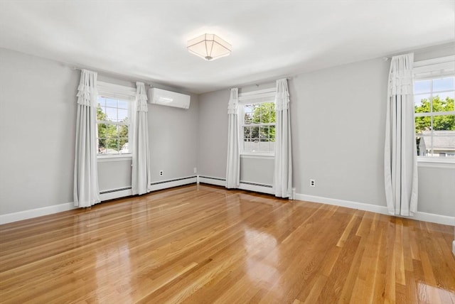 15 Janet Rd, Arlington, MA 02474 - empty room with a wall unit AC, light wood-style floors, and baseboards