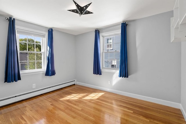 15 Janet Rd, Arlington, MA 02474 - spare room with baseboard heating, wood finished floors, and baseboards