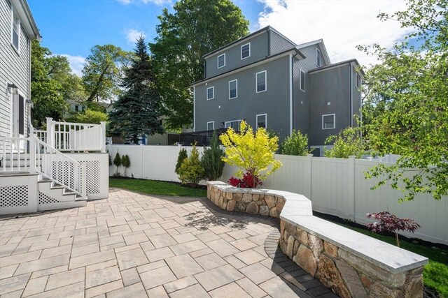 15 Janet Rd, Arlington, MA 02474 - fenced backyard featuring a patio and stairs