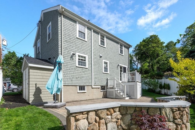 15 Janet Rd, Arlington, MA 02474 - back of property with a patio area, stairway, and a wooden deck