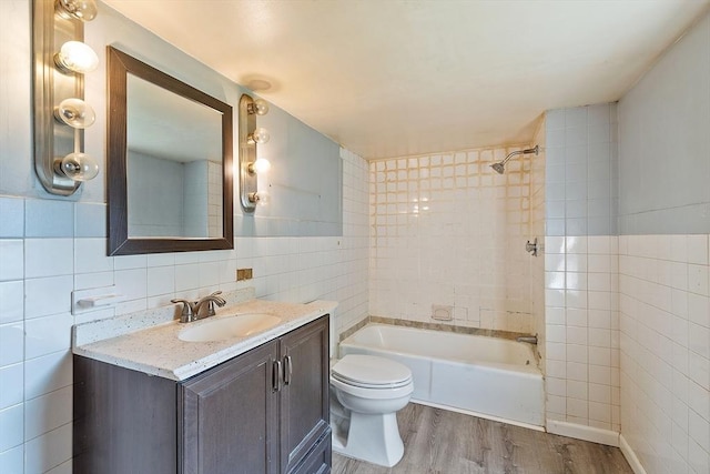 22 Taylor St Unit 1, Gloucester, MA 01930 - full bathroom featuring tile walls, wood finished floors, vanity, and shower / washtub combination
