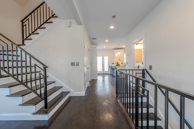 staircase with wood-type flooring and french doors