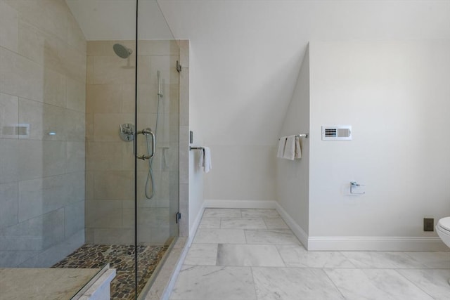 bathroom featuring walk in shower, toilet, and lofted ceiling