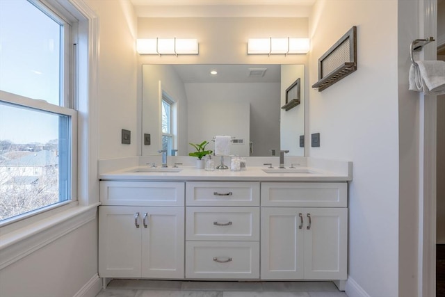 bathroom featuring a wealth of natural light and vanity