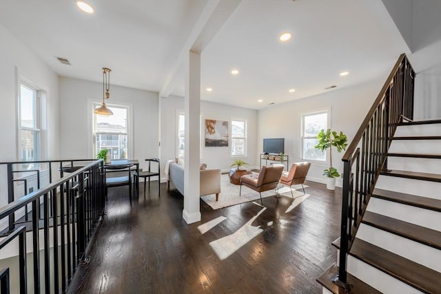 living room featuring a wealth of natural light and dark hardwood / wood-style flooring