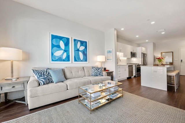 living room featuring recessed lighting and dark wood-style floors