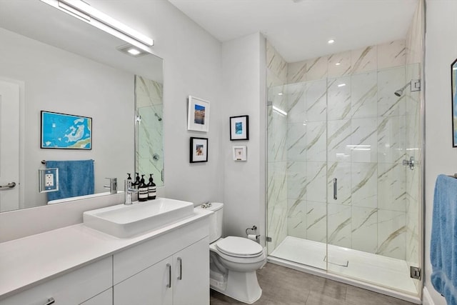 bathroom with vanity, toilet, and a marble finish shower