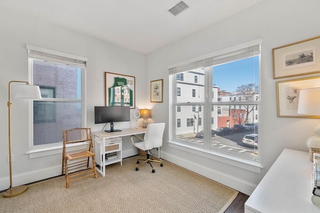 office area featuring visible vents and baseboards