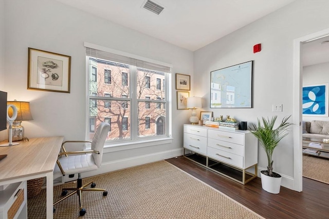 office area featuring visible vents, plenty of natural light, dark wood-type flooring, and baseboards