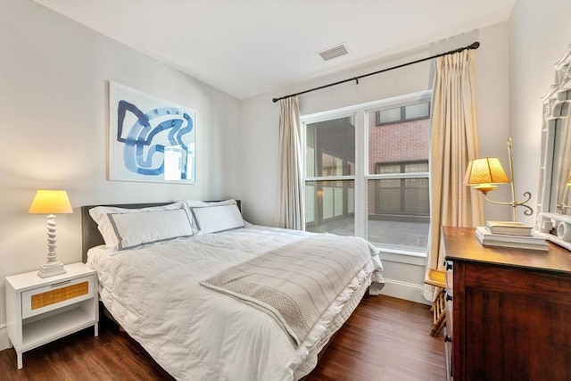 bedroom featuring dark wood finished floors and visible vents