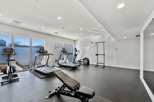 exercise room with recessed lighting, visible vents, and baseboards