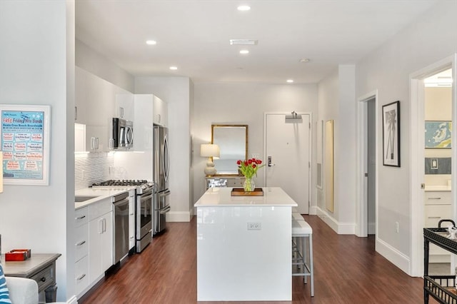 kitchen with a breakfast bar, modern cabinets, a kitchen island, and stainless steel appliances