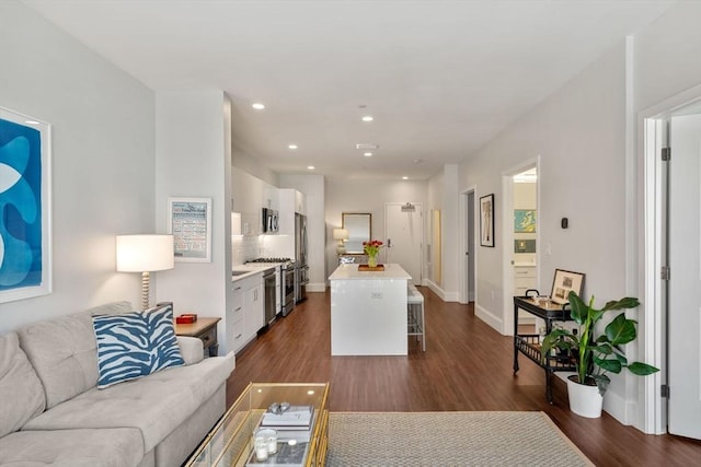 living area with recessed lighting, baseboards, and dark wood-style flooring