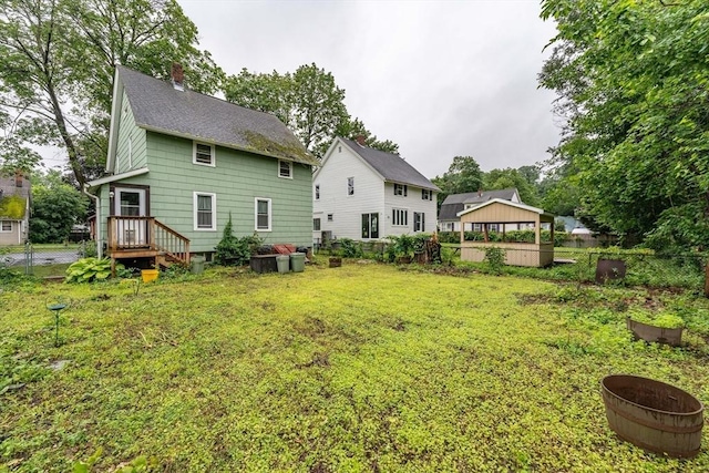 58 Field St, West Springfield, MA 01089 - back of house with a chimney, roof with shingles, and a gazebo