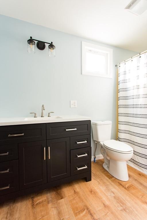 bathroom featuring hardwood / wood-style floors, vanity, and toilet