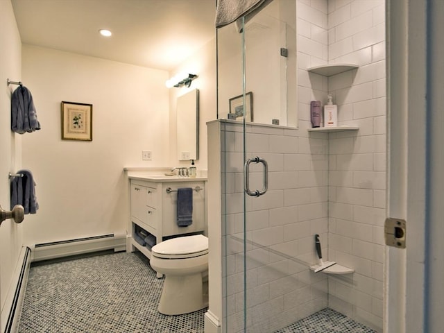 full bathroom with tile patterned floors, a baseboard heating unit, a stall shower, and vanity