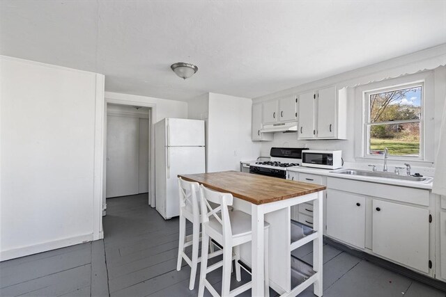 9 Nonantum Rd, Marblehead, MA 01945 - kitchen with white appliances, a sink, under cabinet range hood, wood counters, and white cabinets