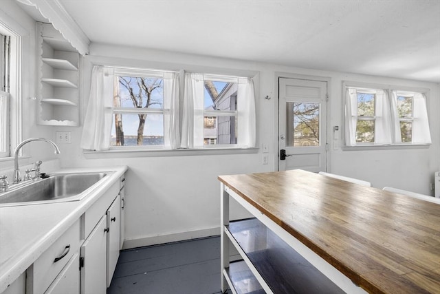 9 Nonantum Rd, Marblehead, MA 01945 - kitchen with a sink, healthy amount of natural light, baseboards, and white cabinetry