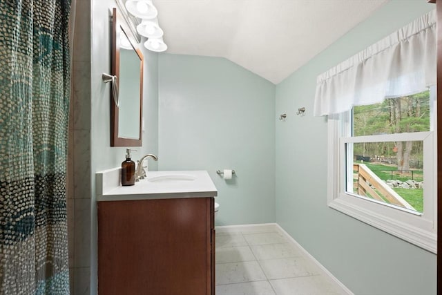 full bath with vanity, baseboards, vaulted ceiling, and curtained shower