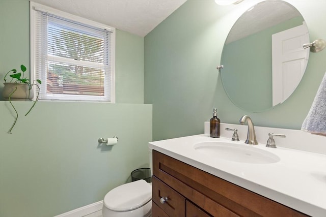 bathroom featuring toilet and vanity