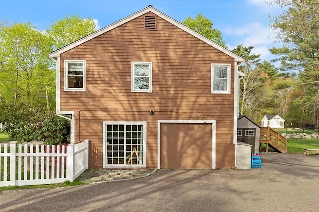 exterior space with a garage, fence, and driveway
