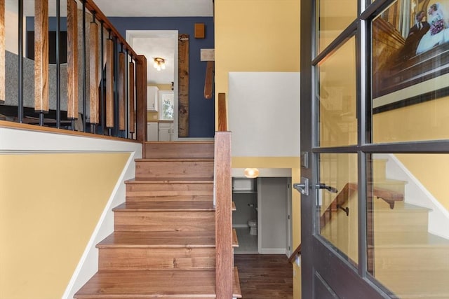 staircase featuring wood finished floors