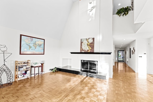 living room with high vaulted ceiling and light parquet floors