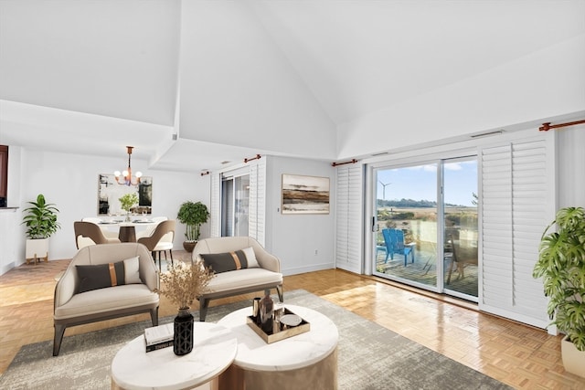 living room featuring high vaulted ceiling, light parquet flooring, and an inviting chandelier