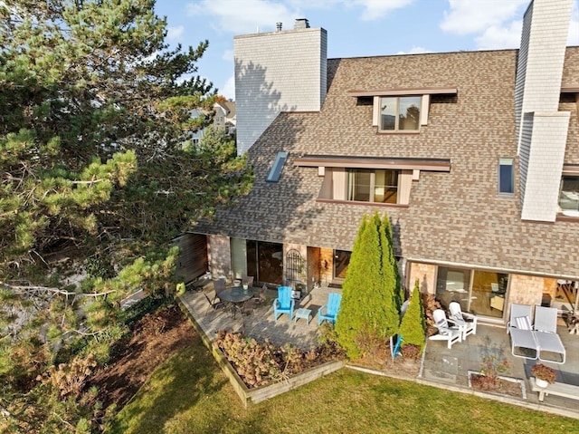 back of house featuring a patio and a lawn