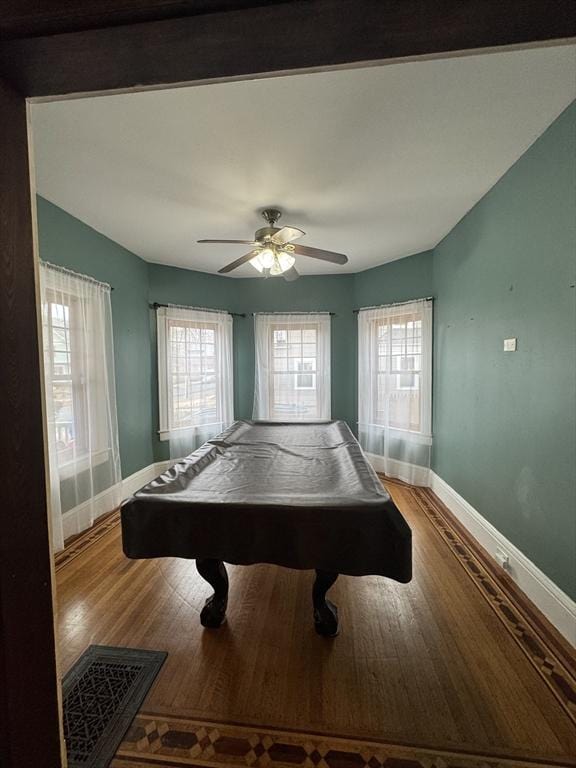 game room featuring wood-type flooring, billiards, ceiling fan, and a wealth of natural light