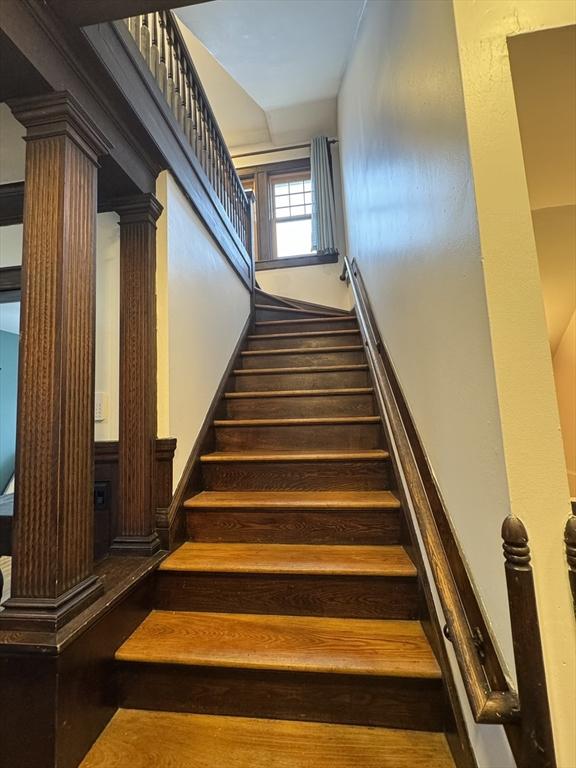 stairs featuring ornate columns