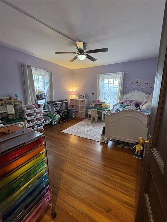 bedroom with ceiling fan and dark hardwood / wood-style floors