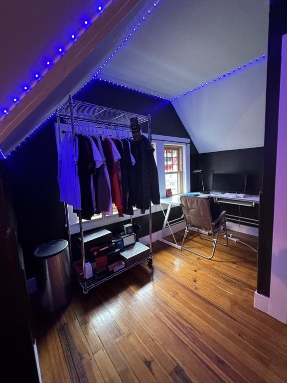 interior space with lofted ceiling and hardwood / wood-style flooring