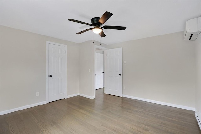 216 Pineview Cir, Agawam, MA 01001 - unfurnished bedroom featuring an AC wall unit, wood finished floors, baseboards, and ceiling fan