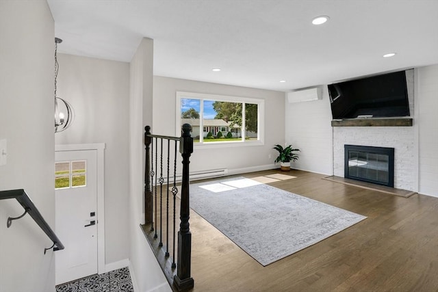 216 Pineview Cir, Agawam, MA 01001 - living area featuring baseboards, wood finished floors, a baseboard heating unit, a fireplace, and recessed lighting