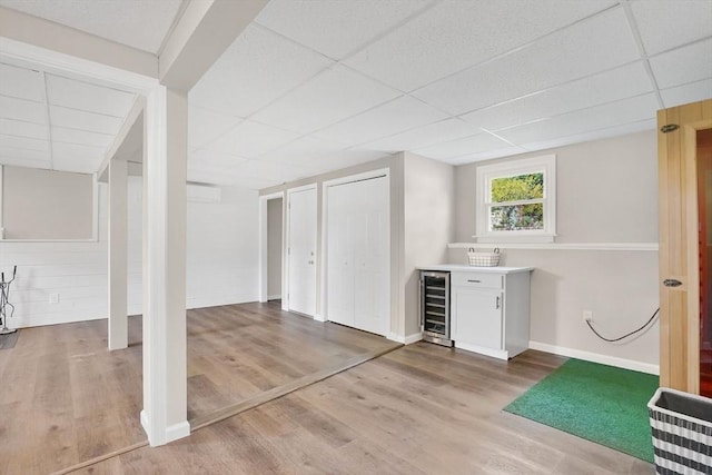 216 Pineview Cir, Agawam, MA 01001 - below grade area featuring wine cooler, a paneled ceiling, a bar, wood finished floors, and baseboards