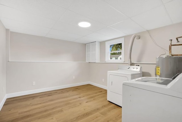 216 Pineview Cir, Agawam, MA 01001 - laundry room with washing machine and clothes dryer, electric water heater, light wood-style floors, and baseboards