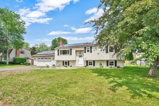 216 Pineview Cir, Agawam, MA 01001 - bi-level home with driveway, a garage, a chimney, and solar panels