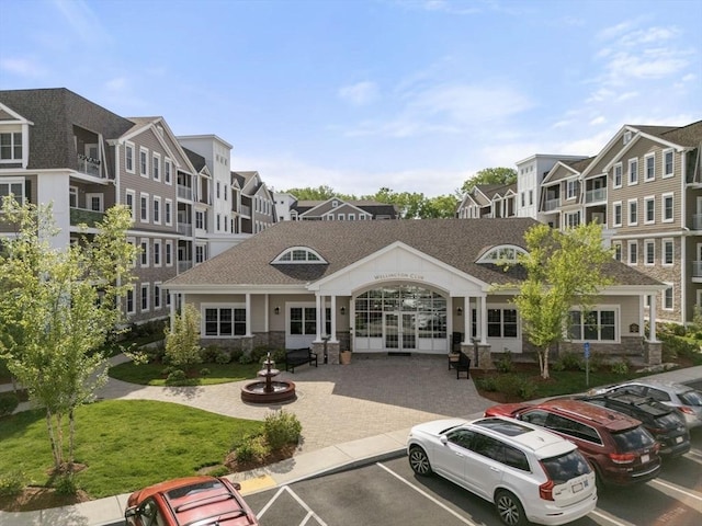 320 Middlesex Ave Unit D103, Medford, MA 02155 - view of building exterior featuring uncovered parking and a residential view