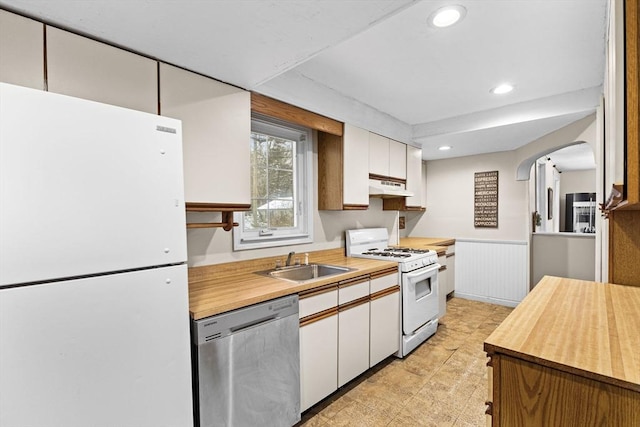 kitchen featuring white cabinets, white appliances, and sink