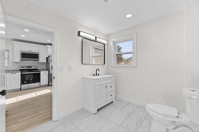 bathroom with toilet and vanity