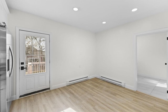 doorway to outside with light wood-type flooring and baseboard heating