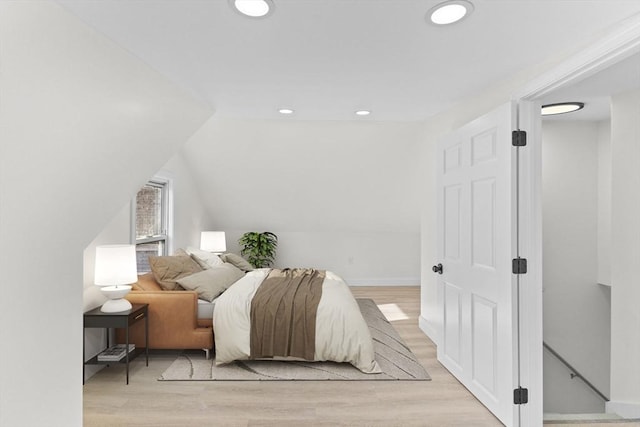 bedroom featuring vaulted ceiling and light hardwood / wood-style flooring