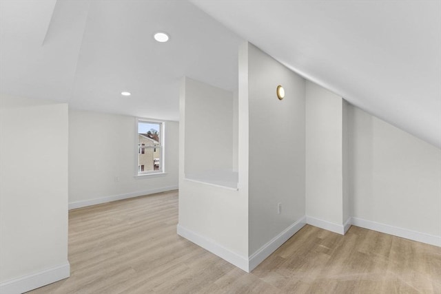 bonus room featuring vaulted ceiling and light hardwood / wood-style floors