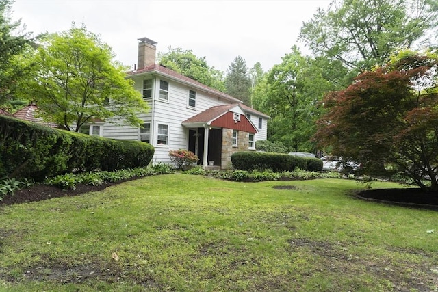 118 Dudley Ln, Milton, MA 02186 - back of property with a lawn, a chimney, and stone siding