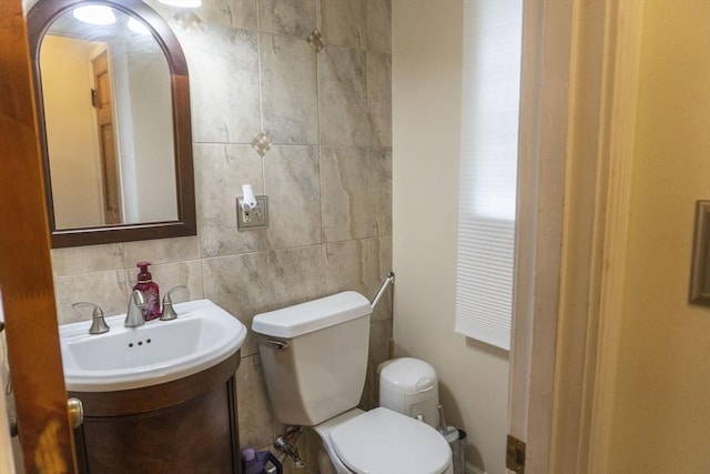 118 Dudley Ln, Milton, MA 02186 - half bathroom featuring toilet, vanity, and tile walls
